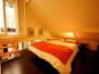 Mezzanine bedroom with queen sized bed, overlooking the skylight