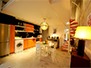 Kitchen and dining area with stairs leading to bedroom mezzanine